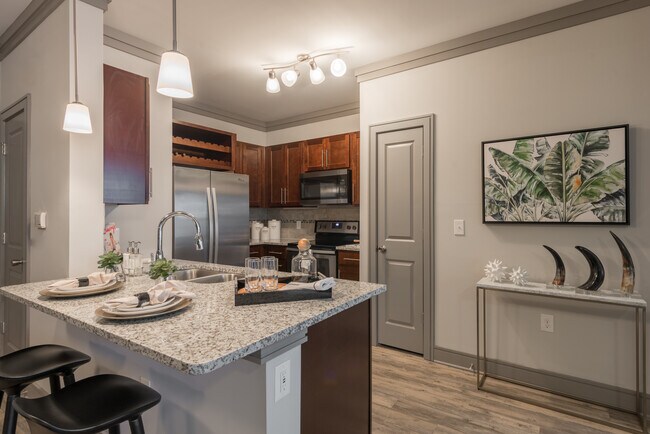 Modern Kitchens with oak shaker-style cabinetry, pendant lighting, granite countertops, and stainless steel appliances - Avalon Perimeter Park Apartments