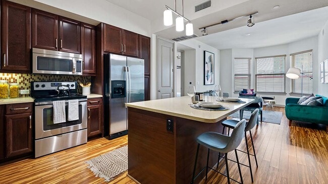Griffis Uptown apartment kitchen with stainless steel appliances. - Griffis Uptown