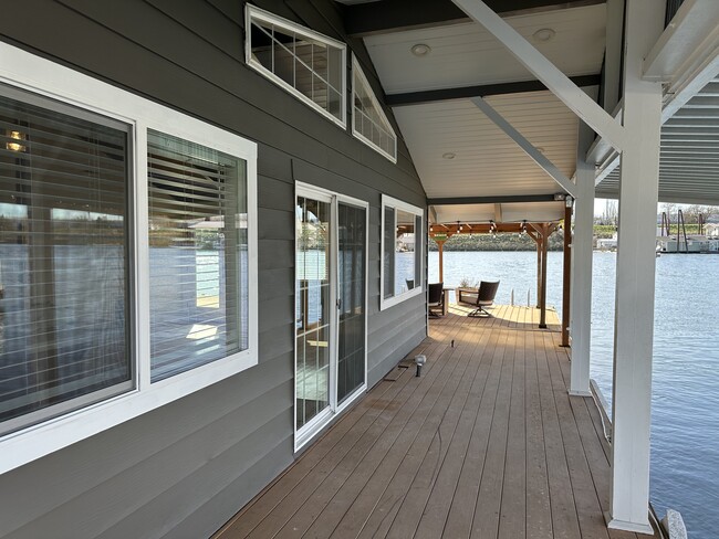 HUGE deck in front of the house and big covered deck offer tons of outdoor space. - 1879 N Jantzen Ave