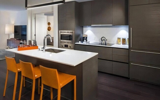 A kitchen island that seats three and still leaves room to prep and plate.