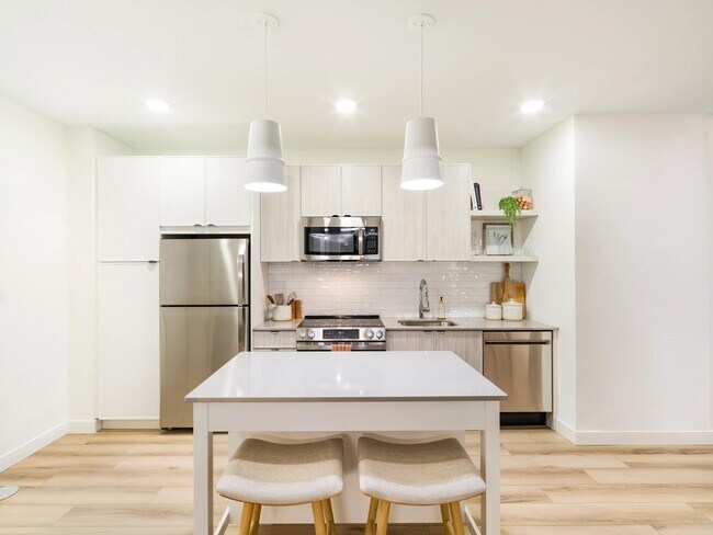 A streamlined kitchen with clean lines, ample storage, and a flexible island for everyday dining. - Modera Revere Beach