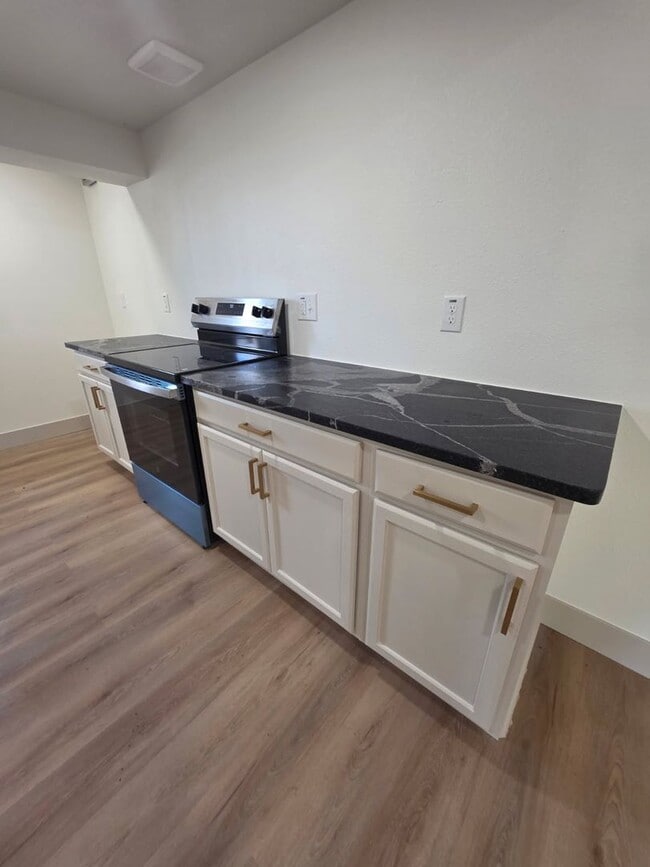 Photo - Studio Apartment with bathroom, kitchen & utility area on the lower level of property.