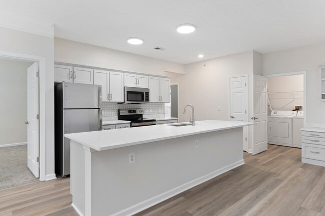 The Charleston Magnolia Premium Renovated Kitchen with Quartz Countertops, Modern Backsplash, Stainless Steel Appliances & Shaker Cabinets