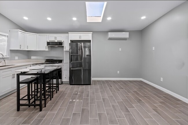 Skylight & air conditioning and heat splits ceramic tile floors throughout gallery Appliances & w/d - 4159 La Salle Ave