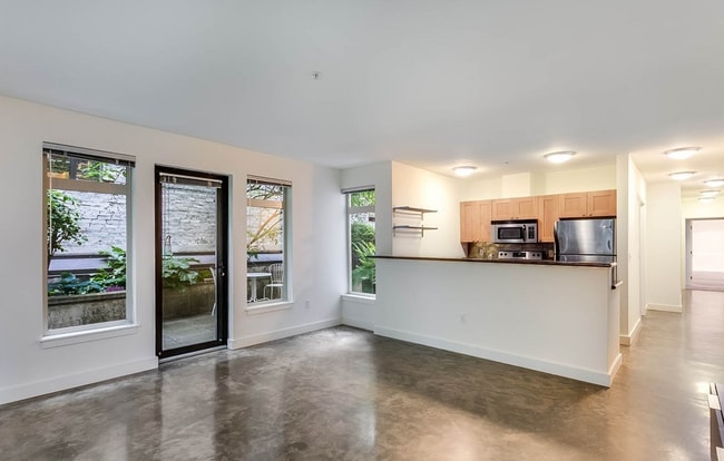 Open living room with concrete floors - 1610 Belmont Ave Unit 213