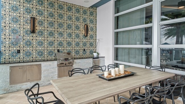 Dine al fresco in refined comfort, just steps from the water