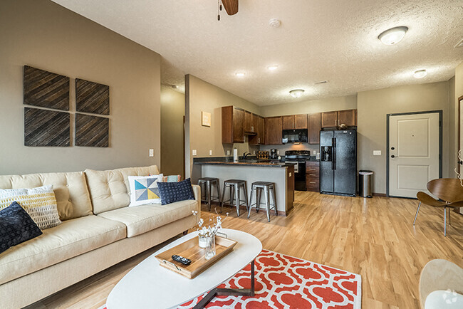 Open-concept living space with hardwood-like flooring. - Villas of Omaha at Butler Ridge Rental