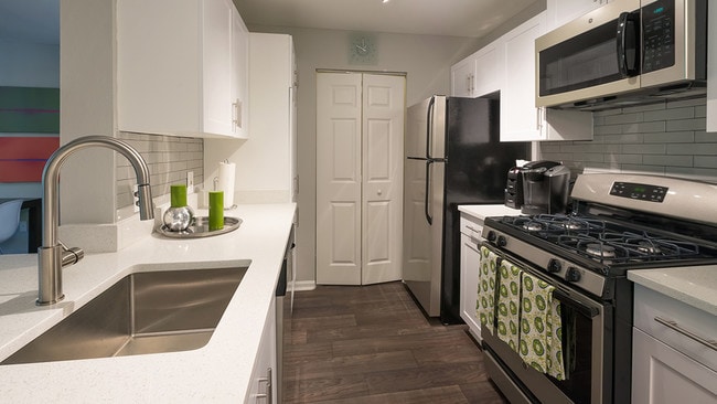 Redesigned kitchens with granite counters, stainless steel appliances and subway tile - Alister Quincy Apartments