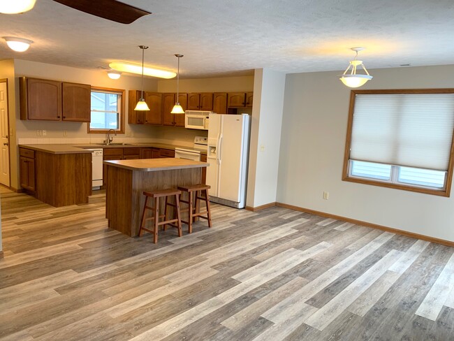 Large dining area with new vinyl plank flooring - 3611 McLaughlin Dr. Townhome