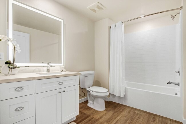 Bathroom with backlit LED vanity mirrors
