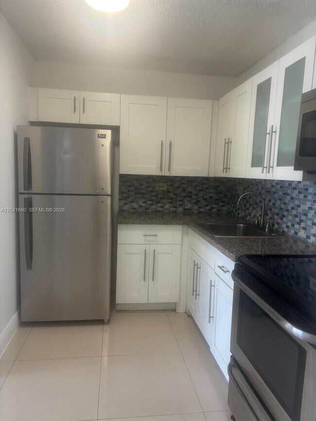 Building Photo - 7120 NW 179th St Unit 106