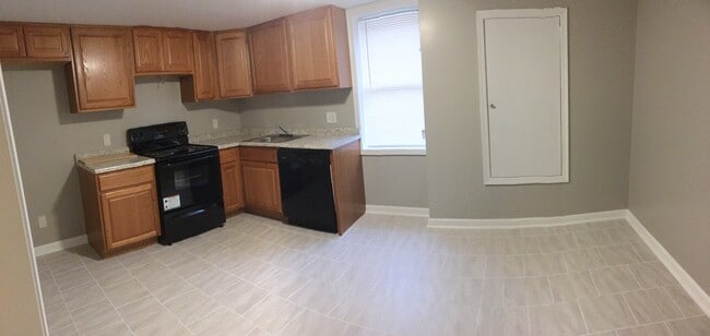 Kitchen opens to dining room - Castle Manor Apartments