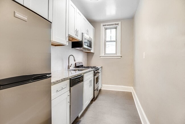 Renovated kitchen with granite countertops and stainless steel appliances