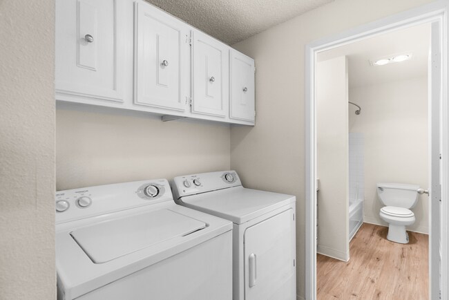 Modern convenience with a dedicated laundry and bathroom space. - Ridgedale Apartments