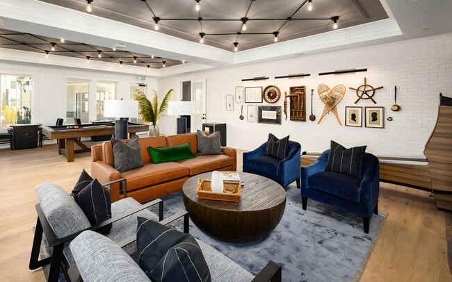 There is a sofa and armchairs here for whoever is sitting a round out.
