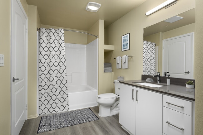 Renovated Package I bath with quartz countertops, white cabinetry, and hard surface vinyl plank flooring
