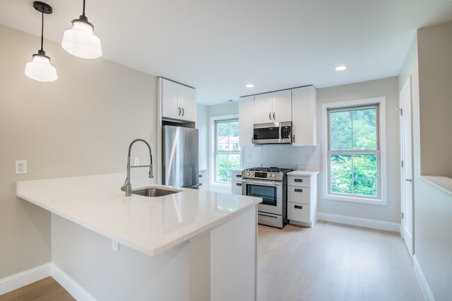 Welcome to Waterfront at the Strand, where modern design meets comfort. This stunning kitchen features sleek finishes, ample natural light, and a spacious layout perfect for culinary adventures. Schedule your tour today and envision your new home! - Waterfront at the Strand