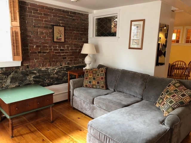 Wood floors, exposed brick, sectional couch - 2 Emmons Pl Condo Unit 2A