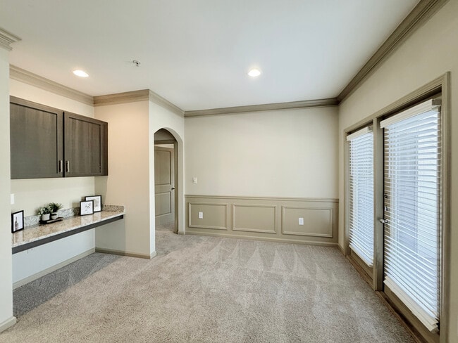 Spacious Open-Concept Living and Dining Area with Built-In Desk and Access to a Private Balcony - Eagle's Brooke