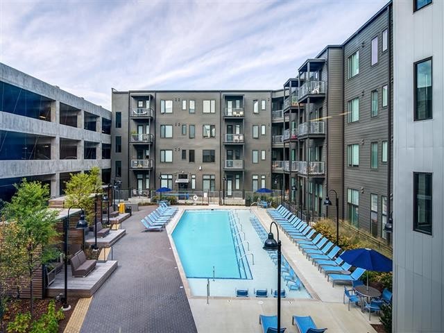 Outdoor Swimming Pool and Lounge Area - The Flats at Taylor Place Apartments