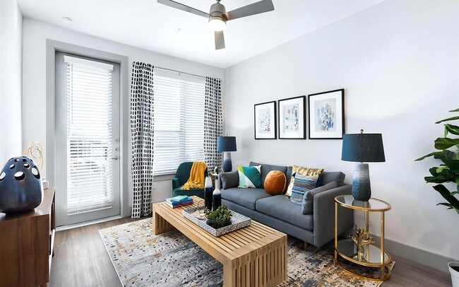 Bright Living Room with Expansive Windows and Modern Ceiling Fan - Rhythm