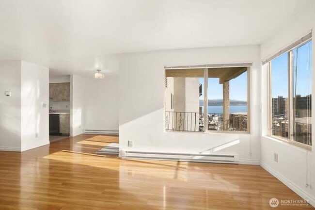 Open concept living and dining room with lake view - 9030 Seward Park Ave S Unit 411