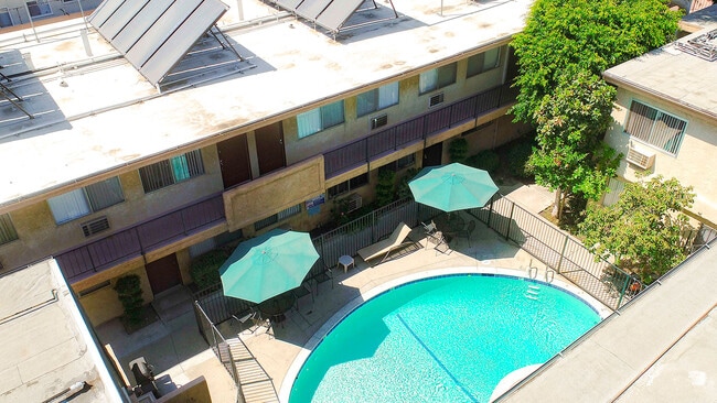 Aerial view of gated community pool with lounging space.