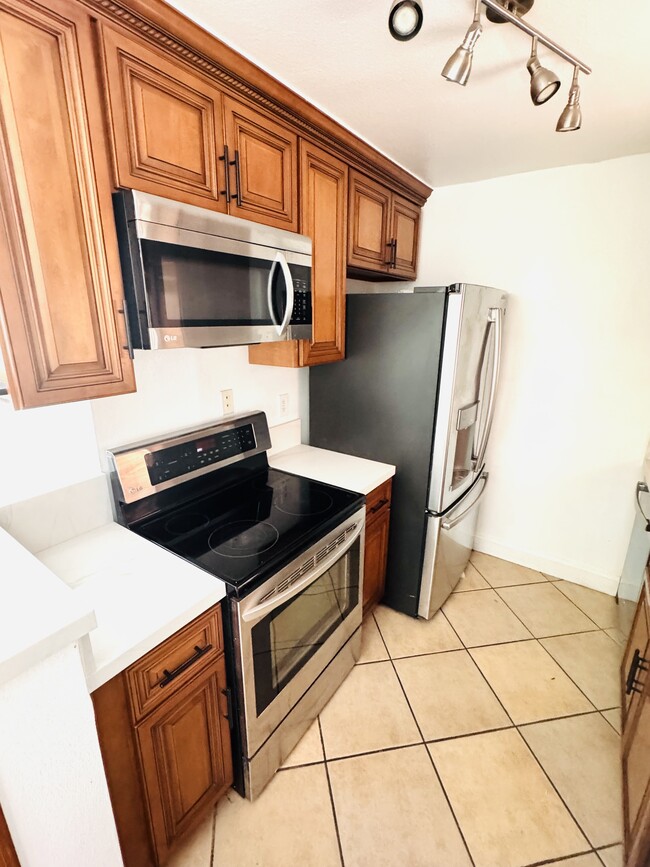 Kitchen Stainless steel microwave, stove, and fridge - 2507 E 15th St Unit 104