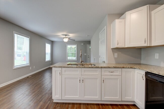 Photo - Two Story Duplex With Hardwood Flooring and White Cabinetry