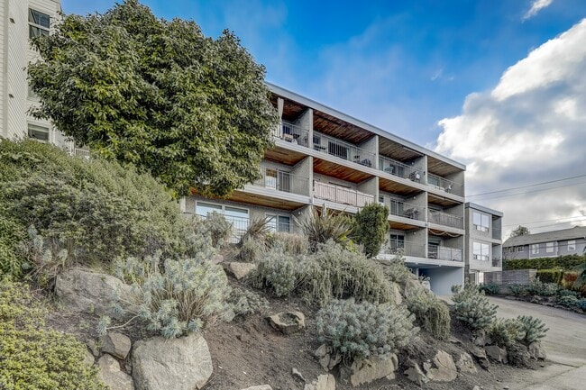 An exterior view of the building showcasing its architectural details and well-maintained landscaping, creating an inviting and aesthetically pleasing environment. - Alaska 45