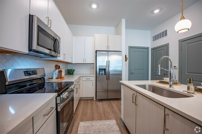 Modern kitchen with sleek stainless steel appliances.