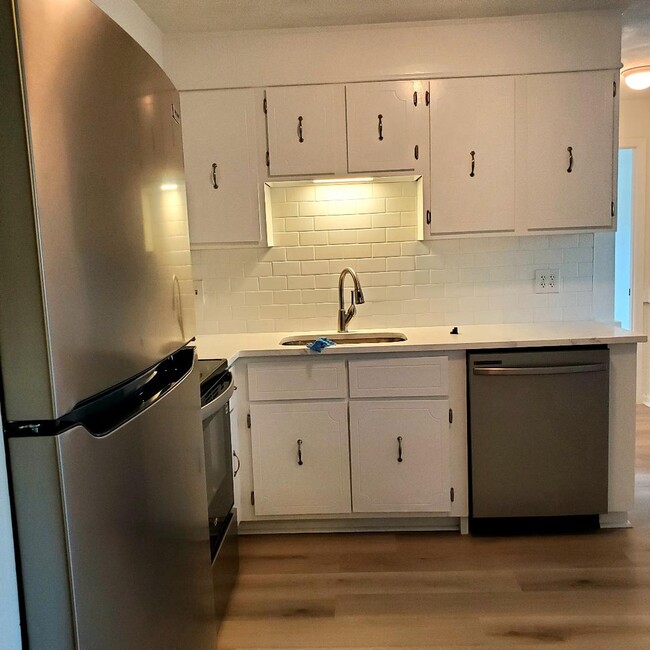 Kitchen white cabinets with chrome hardware - 49 Spencer Rd Unit H 30