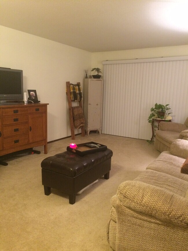 Open and inviting living room with walkout to a beautiful three season porch. - 132 Demont Ave. East Unit 239