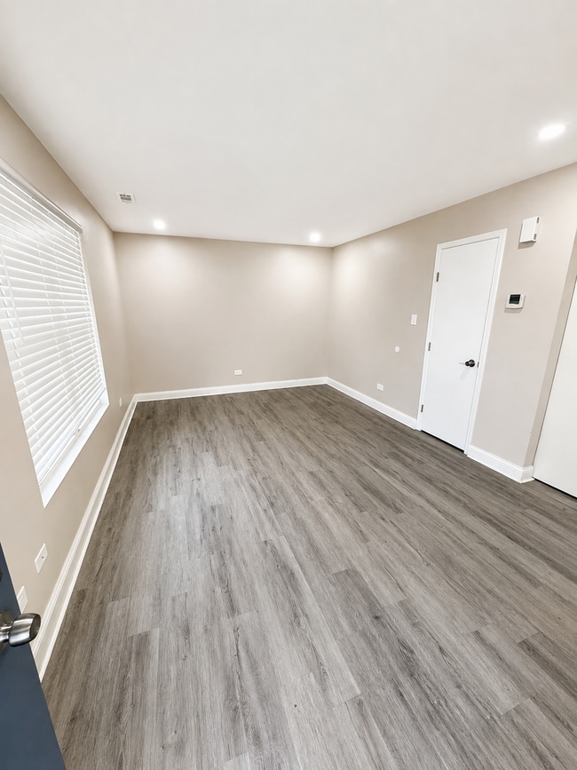Photo - Updated 2-bedroom apartment with parking, front/rear access, modern flooring, full kitchen, and l... Unit C