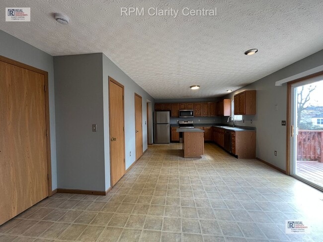 Photo - Spacious 4-Bedroom Home with Fenced Backyard, Deck, and 2-Car Garage