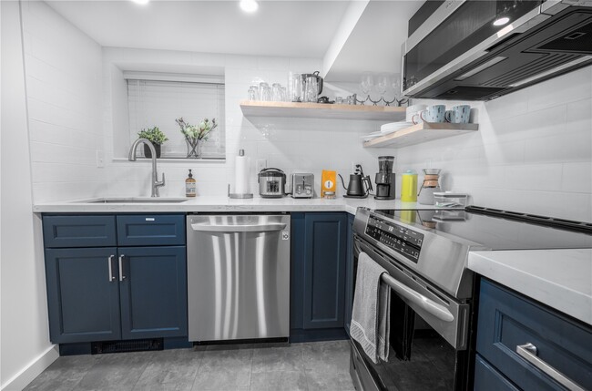 Kitchen with newer appliances including LG dishwasher - 1514 NW 70th St Apartments