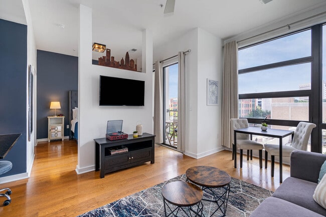 Living area with Smart TV. All the artwork showcases local artists. - 525 E 6th Street Unit #404