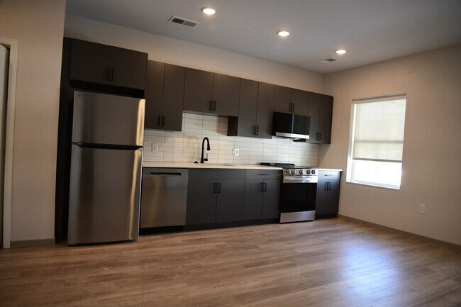 Timeless design with dark granite and charcoal cabinetry - The Guild