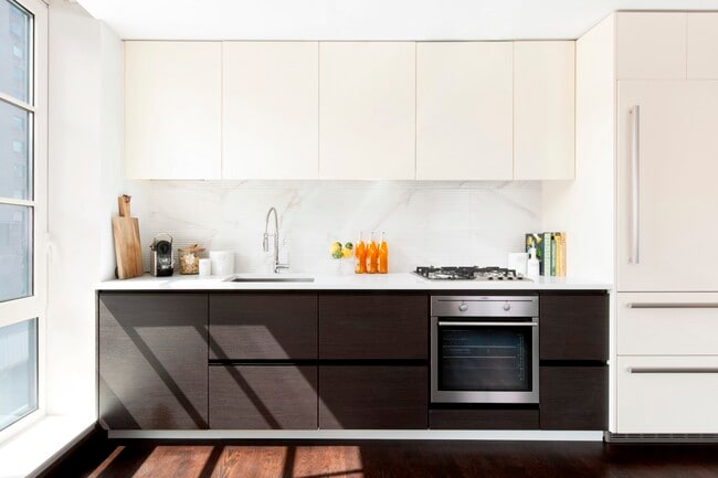 Elevate your lifestyle at The Nathaniel Apartments, featuring modern kitchens with sleek designs and high-end appliances. Enjoy the perfect blend of style and convenience. Explore your new home today and schedule a tour! - The Nathaniel