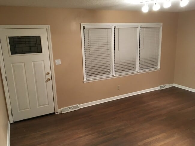 Large living room with beautiful hardwood floors and brand new windows and blinds. - 510 Short St