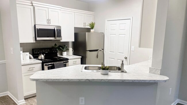Carrara-marble inspired countertops add a touch of flair and style to select apartment kitchens. - 100 South Luxury Apartments
