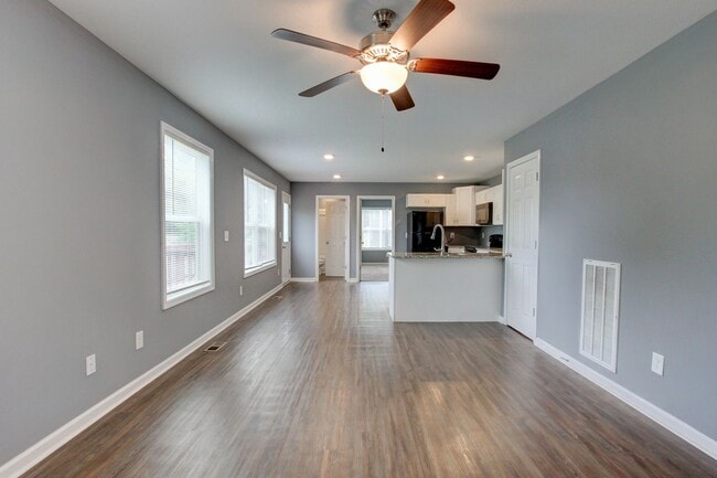 Photo - Two Story Duplex With Hardwood Flooring and White Cabinetry