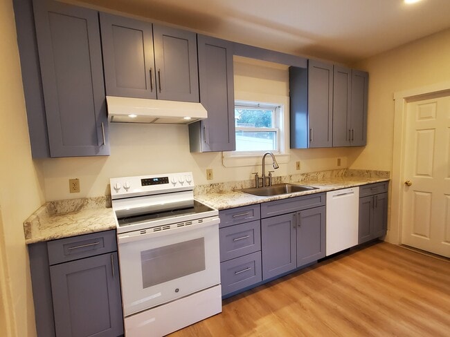 Brand new kitchen granite countertops, induction stove, dishwasher, disposal, new floor! - 484 Main St