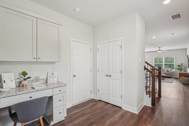 The entrance to the Aberdeen home featuring rich hardwood-style flooring and crisp white walls.