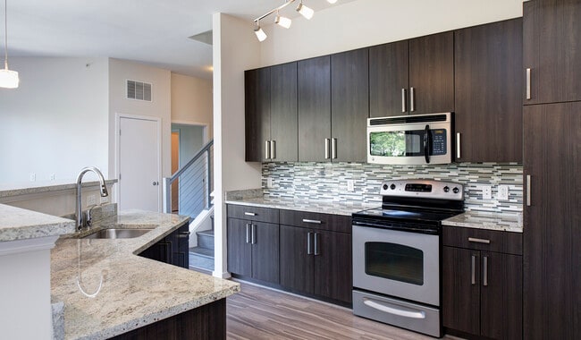 Modern kitchens with granite countertops, stainless steel appliances, and tile backsplash