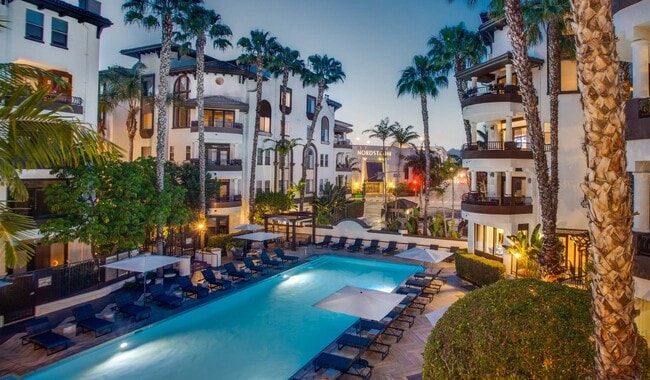 Resort-style saltwater swimming pool with lounge chairs and expansive sundeck - Palazzo West Apartments