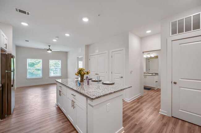 Kitchen with view of bathroom in the background