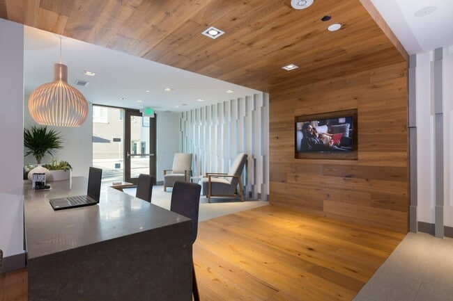 Leasing office with contemporary finishes and welcoming staff at Aster Apartments near BART. - Aster
