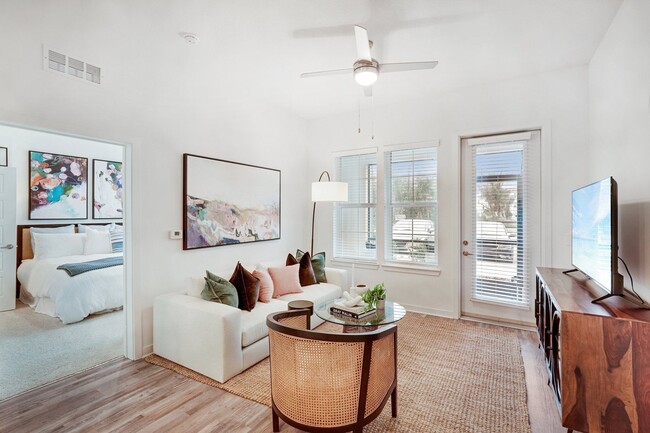 The Pogany living room with bright natural light and access to a screened in porch
