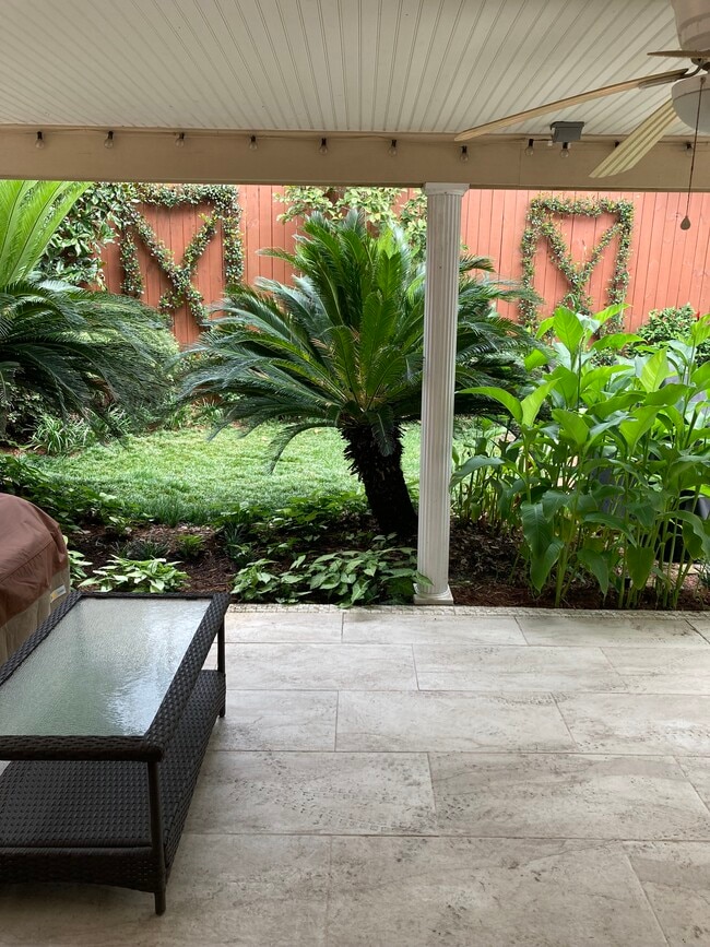 Lovely landscaped garden w/ wooden fence and brick walkway - 1561 Webster St